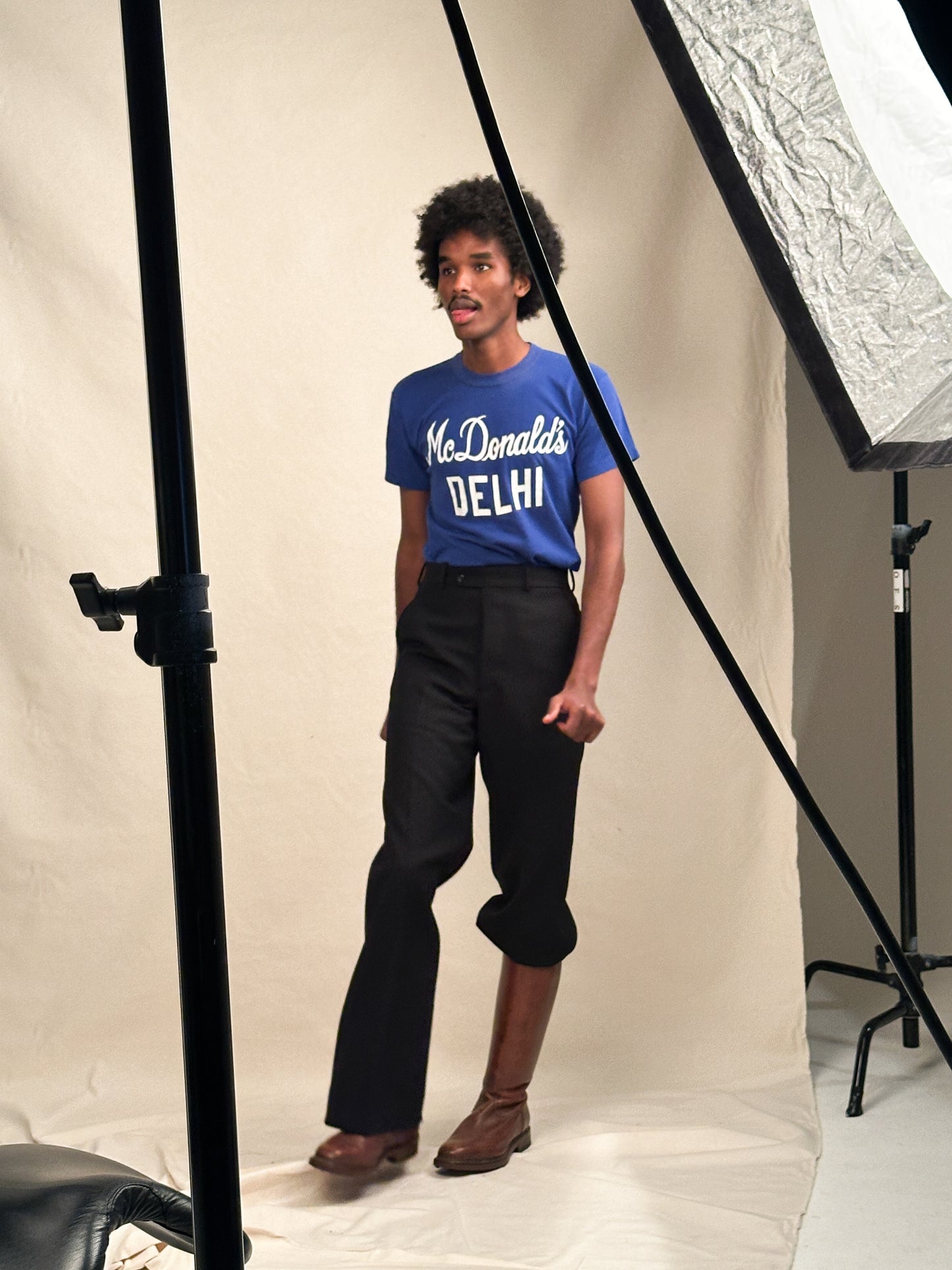 Person wearing a Russell Athletic for McDonald's t-shirt from the 1970s with brown long boots