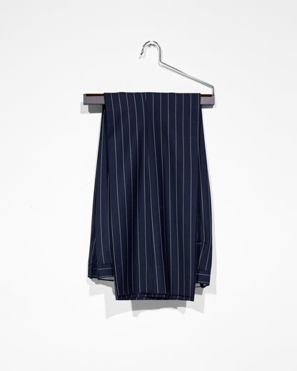 Navy pinstripe pants on a hanger against a white background