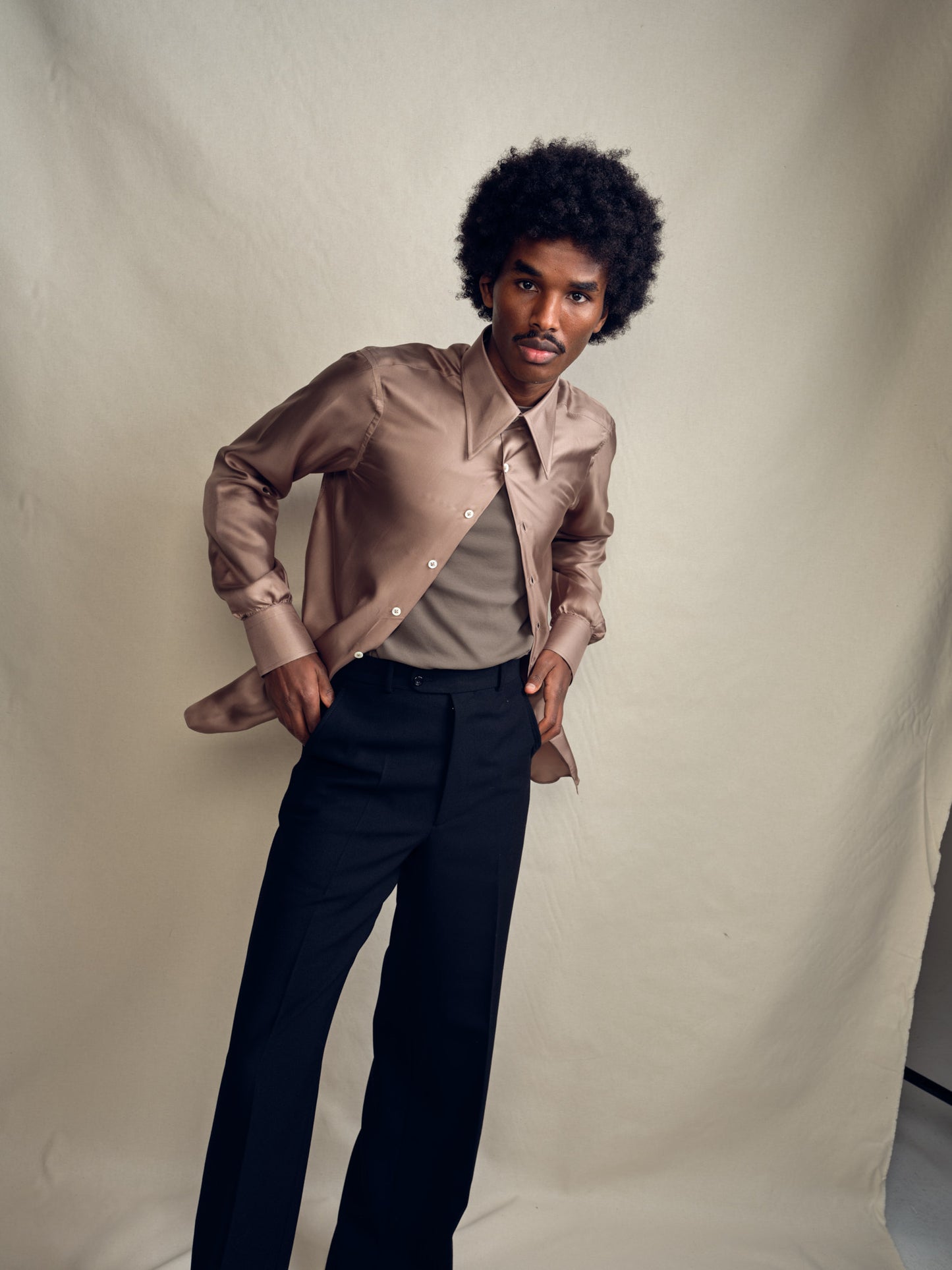 Model wearing Biboja champagne beige silk shirt with signature house collar, single cuffs, made in Italy