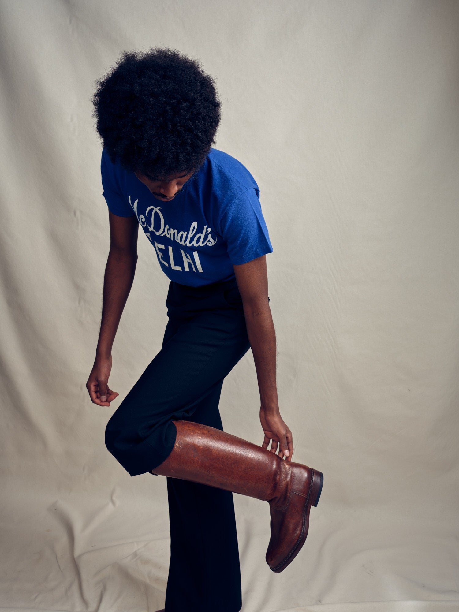 Person wearing a Russell Athletic for McDonald's t-shirt from the 1970s with brown long boots