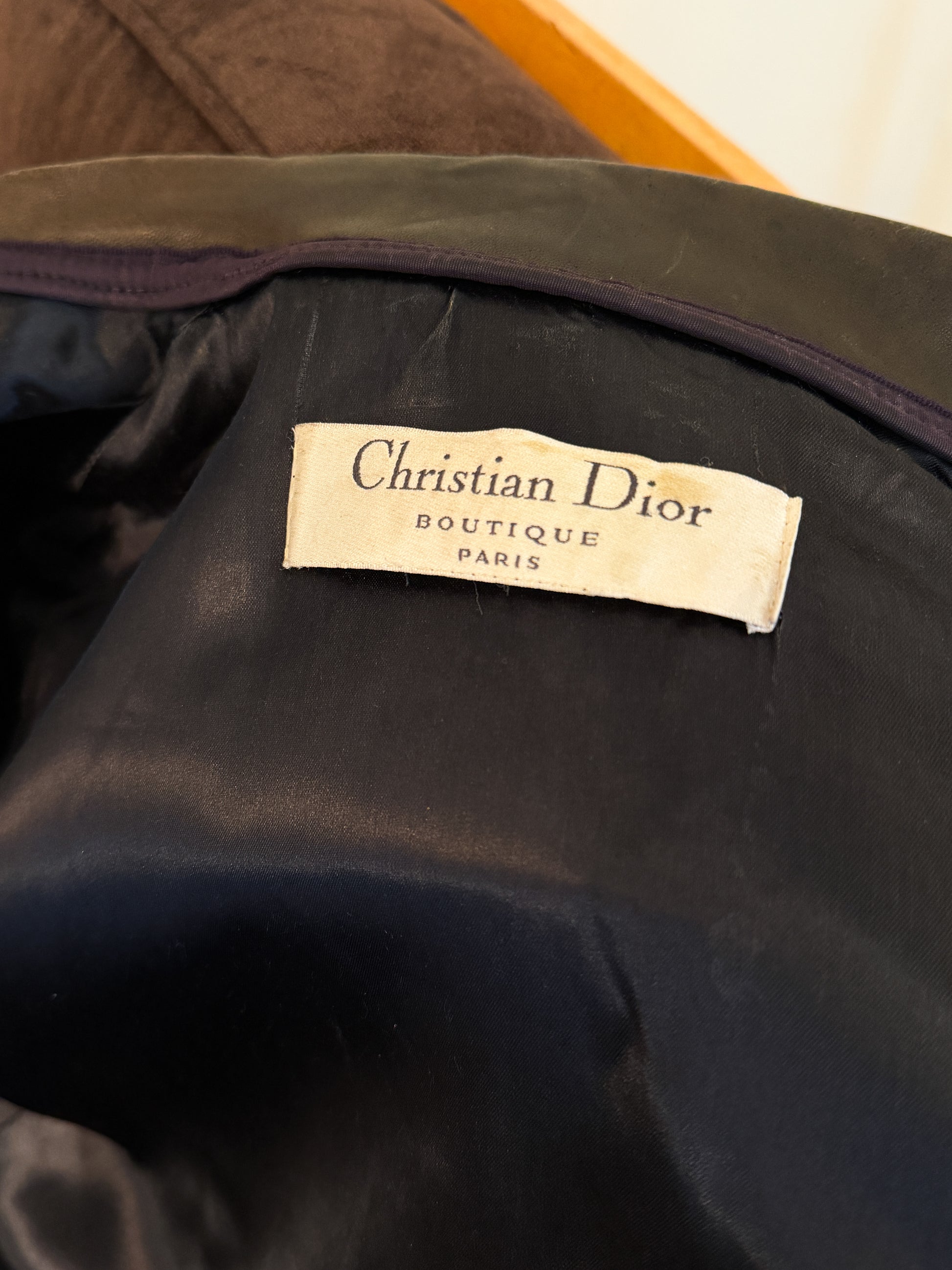 Christian Dior label on a dark jacket background