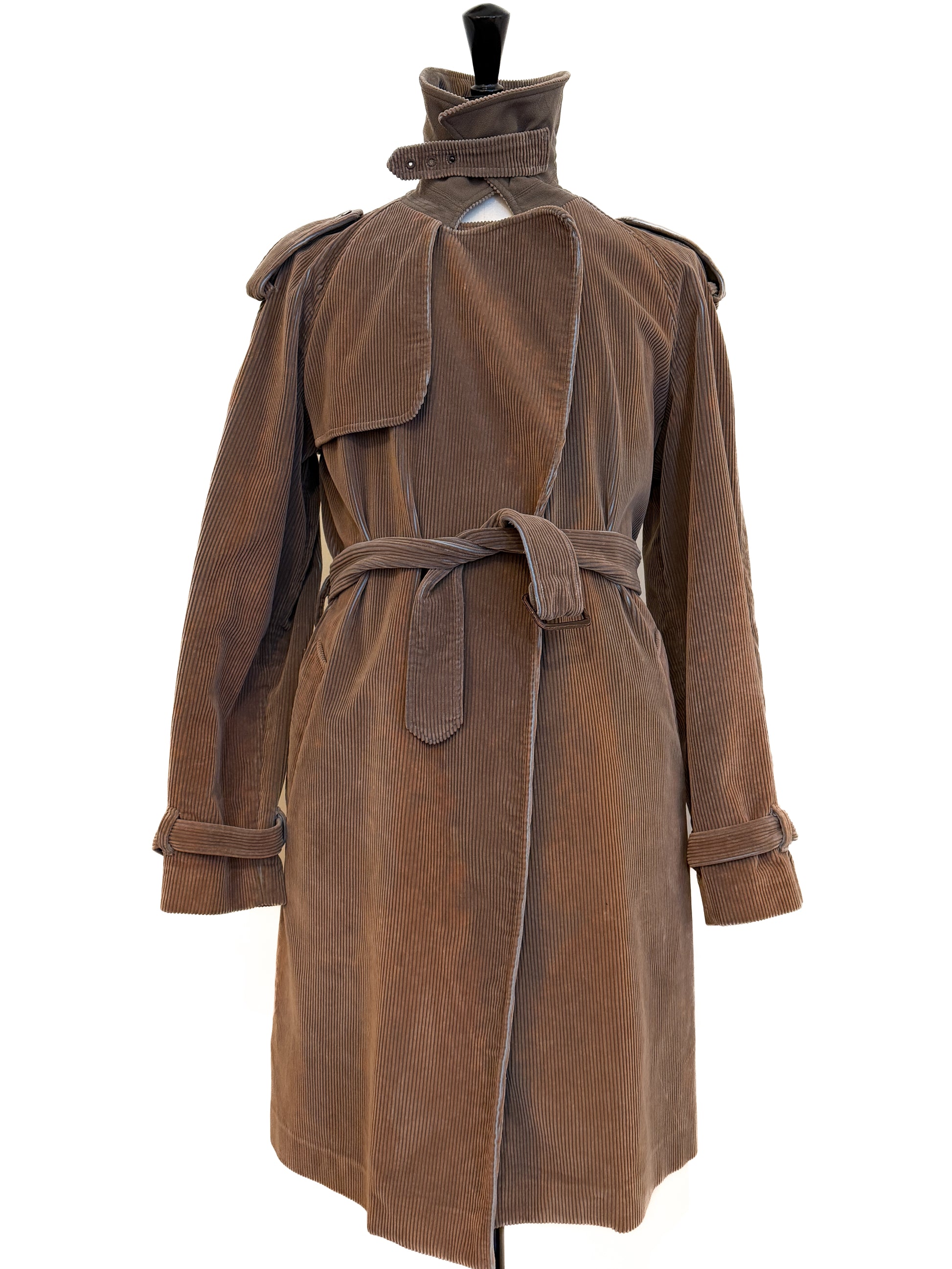 Brown Jean Paul Gautier Homme trenchcoat in corduroy. On a mannequin against a white background