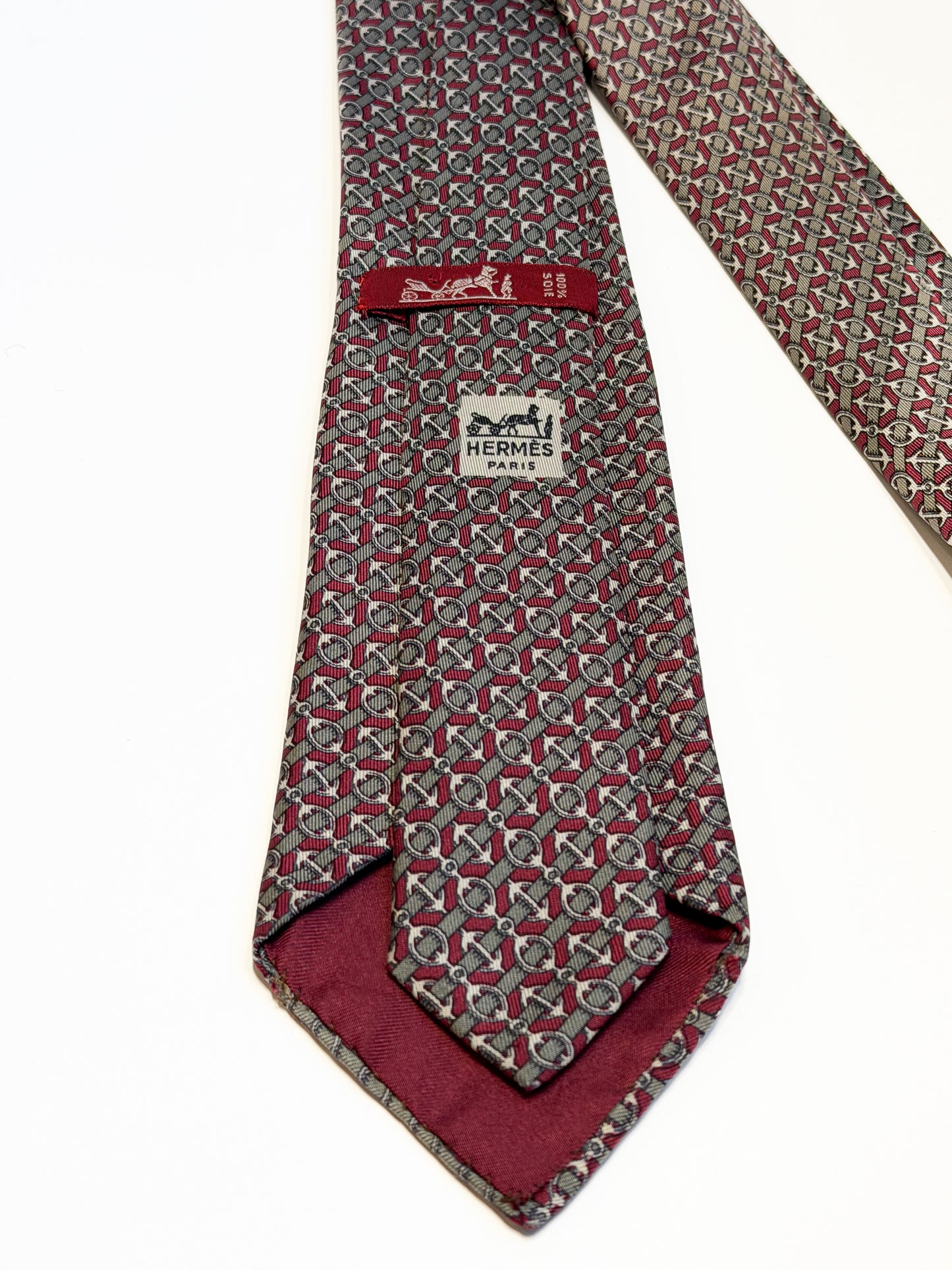 Vintage patterned Hermès silk tie on white background