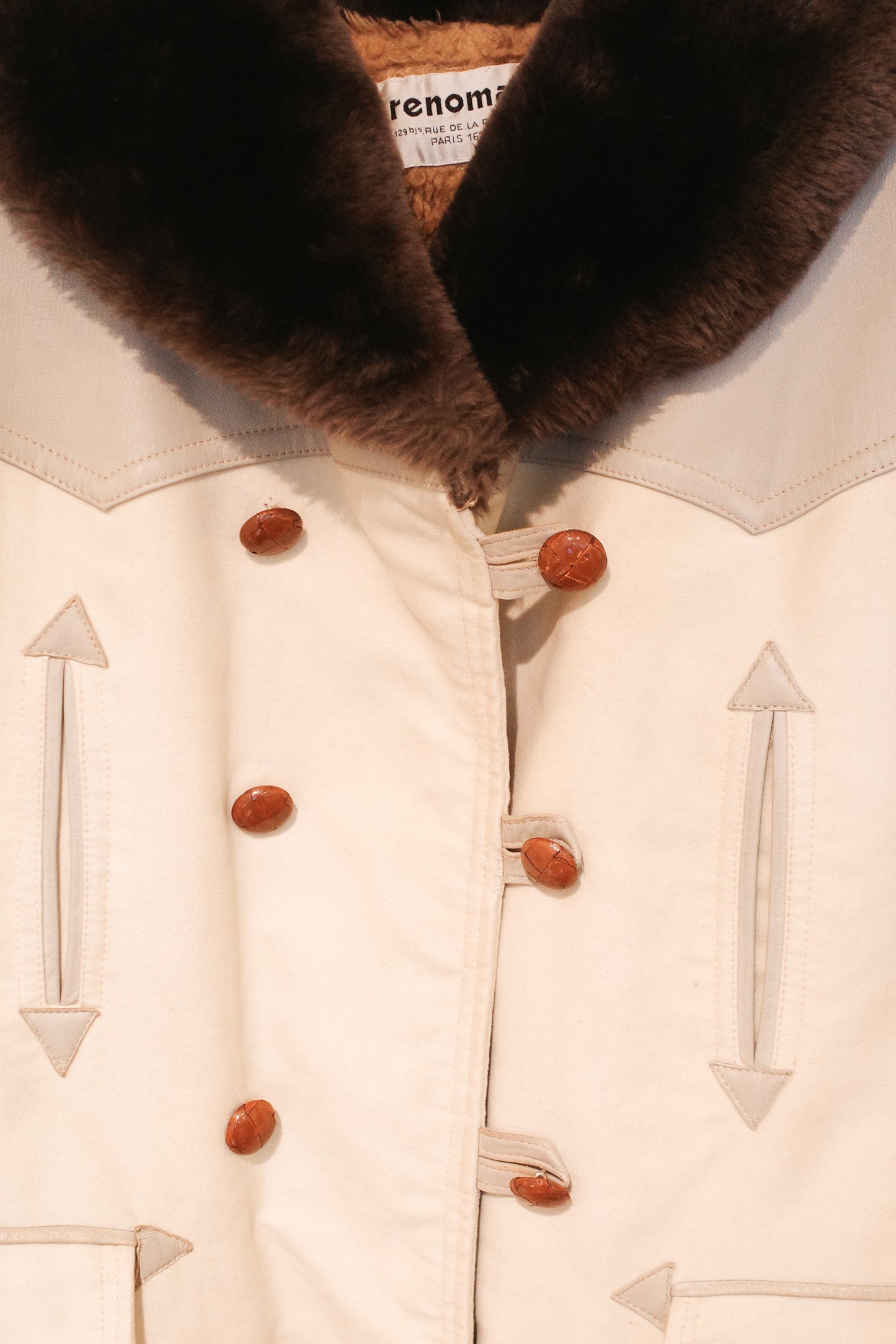 Close-up of Renoma vintage car coat, cream with brown fur collar, double-breasted with arrow detail buttons