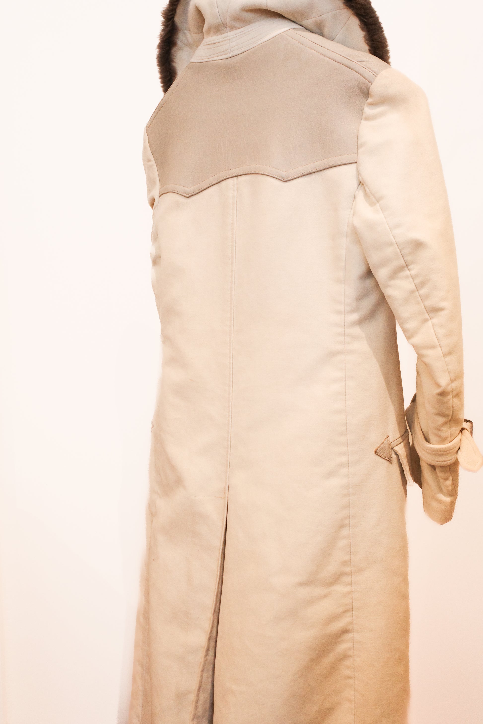  side view of Renoma vintage car coat, cream with brown fur collar, double-breasted with arrow detail buttons